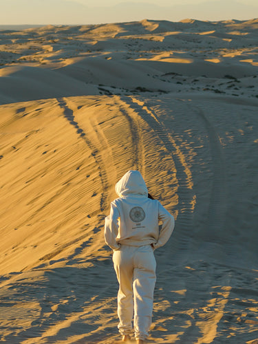 woman walking into desert