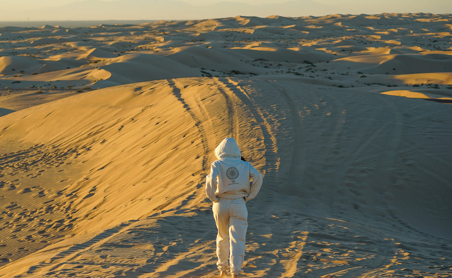 woman walking into desert