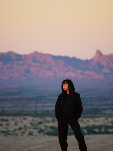 woman standing in dessert omniously 