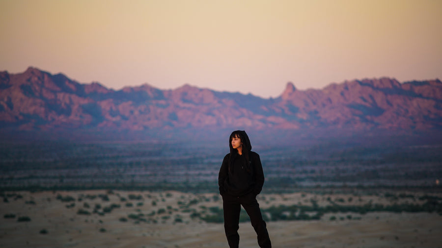 woman standing in dessert omniously 